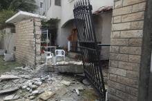 A general view of the damage caused by a bomb blast is seen at the gate of the Iranian ambassador's residence in Tripoli, February 22, 2015. PHOTO BY REUTERS/Ismail Zitouny