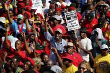 Demonstrators carry placards as they march to the Union building to protest against corruption in Pretoria, September 30, 2015. PHOTO BY REUTERS/Siphiwe Sibeko