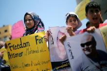 Palestinian demonstrators take part in a protest in solidarity with Mohammad El Halabi, World Vision's manager of operations in Gaza who was accused by Israel of funnelling millions of dollars in aid money to Hamas, organised by foundations and societies benefiting from World Vision in Gaza City, August 7, 2016. PHOTO BY REUTERS/Mohammed Salem