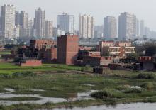 A view of houses and farmland on an island on the River Nile in front of high-rise buildings in Cairo, Egypt, November 25, 2018. PHOTO BY REUTERS/Amr Abdallah Dalsh