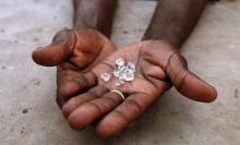 An illegal diamond dealer from Zimbabwe displays diamonds for sale in Manica, near the border with Zimbabwe, September 19, 2010. PHOTO BY REUTERS/Goran Tomasevic
