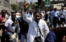 Doctors sing and hold placards during a protest over the disappearance of the leader of their union. PHOTO BY REUTERS/Siphiwe Sibeko