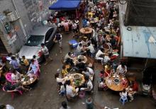 People eat dog meat at a dog meat restaurant district on the day of local dog meat festival in Yulin, Guangxi Autonomous Region, June 22, 2015. PHOTO BY REUTERS/Kim Kyung-Hoon