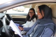 Driving instructor Ahlam al-Somali (R) reads instructions before getting ready to drive with trainee Maria al-Faraj at Saudi Aramco Driving Center in Dhahran, Saudi Arabia, June 6, 2018. PHOTO BY REUTERS/Ahmed Jadallah