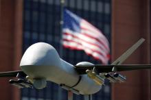 A model of a military drone is seen in front of an U.S. flag as protesters rally against climate change, ahead of the Democratic National Convention, in Philadelphia, Pennsylvania, U.S., July 24, 2016. PHOTO BY REUTERS/Dominick Reuter