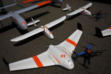 FireFlight UAS unmanned aerial vehicles TwinHawk, Scout, Flanker, and Hawkeye 400, are displayed on the tarmac during "Black Dart", a live-fly, live fire demonstration of 55 unmanned aerial vehicles, or drones, at Naval Base Ventura County Sea Range, Point Mugu, near Oxnard, California, July 31, 2015. PHOTO BY REUTERS/Patrick T. Fallon
