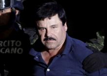 Recaptured drug lord Joaquin "El Chapo" Guzman is escorted by soldiers at the hangar belonging to the office of the Attorney General in Mexico City, Mexico, January 8, 2016. PHOTO BY REUTERS/Henry Romero