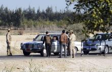 Egyptian security personnel check cars at a checkpoint near the site, where separate attacks on security forces in North Sinai on Thursday killed 30 people, in Arish, North Sinai, Egypt, January 31, 2015. PHOTO BY REUTERS/Stringer