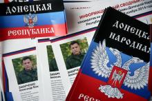 Election information sheets are pictured on display during preparations for the upcoming election, with portraits of Alexander Zakharchenko, separatist leader of the self-proclaimed Donetsk People's Republic, seen on leaflets, at a polling station in Donetsk, eastern Ukraine, October 31, 2014. PHOTO BY REUTERS/Maxim Zmeyev