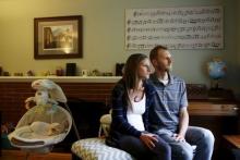Emily and Matt Knudsen sit in their living room in their home in Fremont, California, May 14, 2015. PHOTO BY REUTERS/Beck Diefenbach