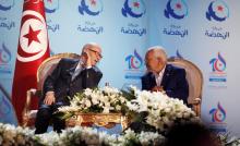 Tunisian President Beji Caid Essebsi (L), talks with Rached Ghannouchi, leader of the Islamist Ennahda movement, during the congress of the Ennahda Movement in Tunis, Tunisia May, 20, 2016. PHOTO BY REUTERS/Zoubeir Souissi