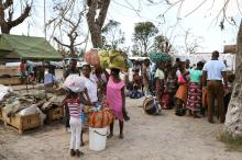 Evacuees from Buzi village carry their belongings as they arrive at the displacement center near the airport, after Cyclone Idai, in Beira, Mozambique, March 25, 2019. PHOTO BY REUTERS/Siphiwe Sibeko