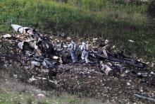 Israeli security forces examine the remains of an F-16 Israeli war plane near the Israeli village of Harduf, Israel, February 10, 2018. PHOTO BY REUTERS/Ronen Zvulun