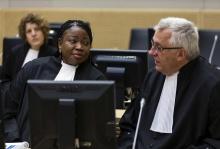 Prosecutor Fatou Bensouda (L) speaks with deputy prosecutor James Stewart in the courtroom of the International Criminal Court (ICC) during the initial appearance of Charles Ble Goude, a youth leader of the Ivory Coast, at The Hague, March 27, 2014. PHOTO BY REUTERS/Michael Kooren
