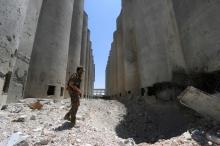 A Syria Democratic Forces (SDF) fighter walks in the silos and mills of Manbij after the SDF took control of it, in Aleppo Governorate, Syria, July 1, 2016. PHOTO BY REUTERS/Rodi Said