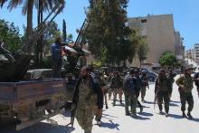 Nusra Front fighters walk with their weapons in Jisr al-Shughour town, after they took control of the area, April 25, 2015. PHOTO BY REUTERS/Ammar Abdullah