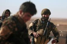 Syrian Democratic Forces (SDF) fighters walk in Tal Samin village, north of Raqqa city, Syria, November 19, 2016. PHOTO BY REUTERS/Rodi Said