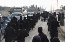 Fighters of al-Qaeda linked Islamic State of Iraq and the Levant parade at the Syrian town of Tel Abyad, near the border with Turkey