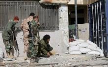 Members of the Libyan pro-government forces, backed by locals, take up positions during clashes with the Shura Council of Libyan Revolutionaries. PHOTO BY REUTERS/Esam Omran Al-Fetori