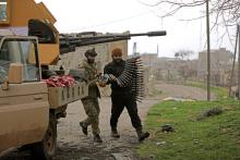 Turkish-backed Free Syrian Army fighters hold an ammunition belt near the city of Afrin, Syria February 21, 2018. REUTERS/Khalil Ashawi