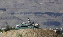 Houthi fighters sit on a tank near the Presidential Palace in Sanaa, March 25, 2015. PHOTO BY REUTERS/Khaled Abdullah