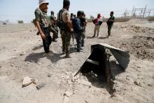 Fighters from the Iraqi Shi'ite Badr Organization stand near a tunnel built by Islamic State fighters on the outskirts of Falluja, Iraq, May 28, 2016. PHOTO BY REUTERS/Thaier Al-Sudani