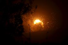 Fire is seen at a military site after it was hit by an air strike on the Faj Attan mountain of Sanaa, March 30, 2015. PHOTO BY REUTERS/Mohamed al-Sayaghi