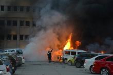 A firefighter tries to extinguish burning vehicles after an explosion outside the governor's office in the southern city of Adana, Turkey, November 24, 2016. PHOTO BY REUTERS/Ihlas News Agency