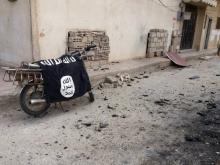 A flag belonging to the Islamic State fighters on a motorbike after forces loyal to Syria's President Bashar al-Assad recaptured the historic city of Palmyra, in Homs Governorate, March 27, 2016. PHOTO BY REUTERS/SANA