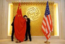 Staff members set up Chinese and U.S. flags for a meeting between Chinese Transport Minister Li Xiaopeng and U.S. Secretary of Transportation Elaine Chao at the Ministry of Transport of China in Beijing, China, April 27, 2018. PHOTO BY REUTERS/Jason Lee