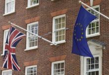 The British Union flag and European Union flag are seen hanging outside Europe House in central London, June 9, 2015. PHOTO BY REUTERS/Toby Melville