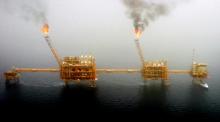 Gas flares from an oil production platform at the Soroush oil fields in the Persian Gulf, south of the capital Tehran, July 25, 2005. PHOTO BY REUTERS/Raheb Homavandi