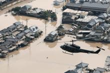 A helicopter flies over Mabi town which was flooded by the heavy rain in Kurashiki, Okayama Prefecture, Japan, in this photo taken by Kyodo July 9, 2018. PHOTO BY REUTERS/Kyodo