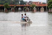 A man and a boy ride a scooter through a flooded road after heavy rains in Prayagraj, India, September 29, 2019. PHOTO BY REUTERS/Jitendra Prakash