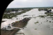 A WFP (World Food Program) helicopter is seen on the flooded airstrip, after heavy rains and floods forced hundreds of thousands of people to leave their homes, in the town of Pibor, Boma state, South Sudan, November 6, 2019. PHOTO BY REUTERS/Andreea Campeanu