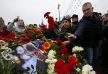 People lay flowers at the site where Boris Nemtsov was recently murdered, in central Moscow, February 28, 2015. PHOTO BY REUTERS/Sergei Karpukhin