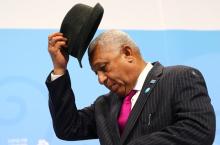 Frank Bainimarama, Prime Minister of Fiji and president of the COP23, takes off his hat at the start of the final session of the U.N. Climate Change Conference 2017 hosted by Fiji but held in Bonn, Germany, November 18, 2017. PHOTO BY REUTERS/Wolfgang Rattay