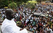 George Weah, a former soccer star and the running mate of presidential candidate Winston Tubman of the Congress for Democratic Change (CDC), looks on as he stands at the balcony after a news conference at his headquarters in Monrovia, November 5, 2011. PHOTO BY REUTERS/Luc Gnago
