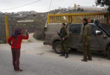A Palestinian girl argues with Israeli soldiers after they detained her 14-year-old brother, who the Israeli military said tried to stab a soldier, in the West Bank town of Bani Naeem, near Hebron, February 21, 2016. PHOTO BY REUTERS/Mussa Qawasma