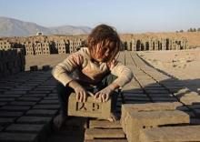An Afghan girl works at a brick-making factory in Nangarhar province, January 6, 2015. PHOTO BY REUTERS/Parwiz