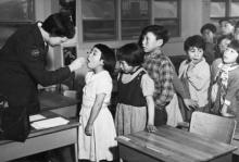 Nurse Desrochers checks a girl's throat while other children wait in line, at the Frobish Bay Federal Hostel in Iqaluit, Nunavut, in a 1959 archive photo. PHOTO BY REUTERS/H. Leclair