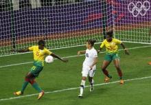 New Zealand's Sarah Gregorius (C) watches as Cameroon's Ysis Sonkeng (L) scores an own goal during their women's football first round Group E match at the City of Coventry Stadium during the London 2012 Olympic Games July 31, 2012. Cameroon's Augustine Ejangue is at right. PHOTO BY REUTERS/Alessandro Garofalo