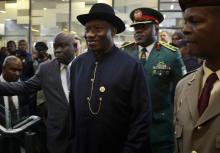 Nigeria's President Goodluck Jonathan (C) arrives for the service for former South African President Nelson Mandela at the First National Bank Stadium, in Johannesburg