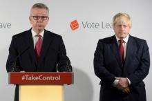 Britain's Justice Secretary Michael Gove (L) speaks as Vote Leave campaign leader Boris Johnson listens at the group's headquarters in London, Britain, June 24, 2016. PHOTO BY REUTERS/Stefan Rousseau