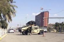 Iraqi security forces secure a road after bomb attacks outside the Green Zone in Baghdad, February 5, 2014. PHOTO BY REUTERS/Thaier al-Sudani