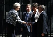 Britain's Prime Minister, Theresa May, shakes hands with Democratic Unionist Party (DUP) Deputy Leader Nigel Dodds, in Downing Street, in central London, Britain, June 26, 2017. PHOTO BY REUTERS/Neil hall