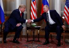 U.S. President Donald Trump and Russia's President Vladimir Putin shake hands as they meet in Helsinki, Finland, July 16, 2018. PHOTO BY REUTERS/Kevin Lamarque