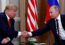 U.S. President Donald Trump and Russia's President Vladimir Putin shake hands as they meet in Helsinki, Finland, July 16, 2018. PHOTO BY REUTERS/Kevin Lamarqu