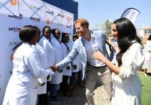 Britain's Prince Harry and his wife Meghan, the Duke and Duchess of Sussex, speak to people at the Youth Employment Services (YES) Hub as they visit a township in Johannesburg, South Africa, October 2, 2019. PHOTO BY REUTERS/Facundo Arrizabalaga