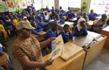 Helen Mashele from South Africa reads the biography of former South African president Nelson Mandela to pupils at Kilimani Primary School in Kenya's capital Nairobi, July 18, 2013. PHOTO BY REUTERS/Thomas Mukoya